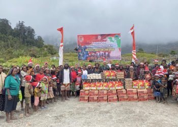 Prajurit TNI Satgas 433 Kostrad saat foto bersama dengan warga sebelum membagikan sembako dan makanan bergizi