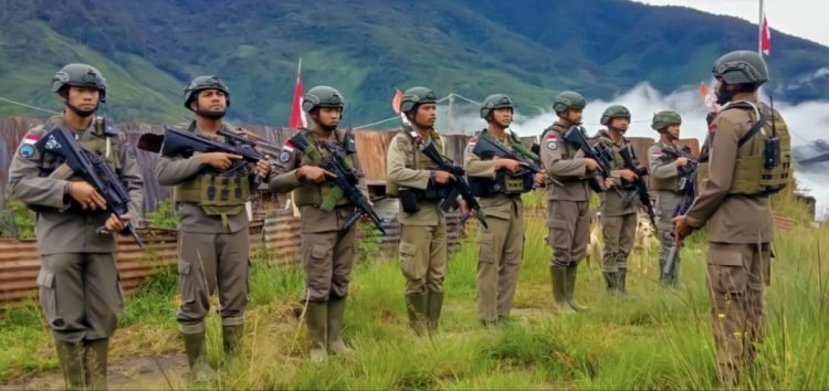 Personel Brimob anggota Satgas Damai Cartenz 2024 mempersiapkan diri sebelum menggelar patroli keamanan.