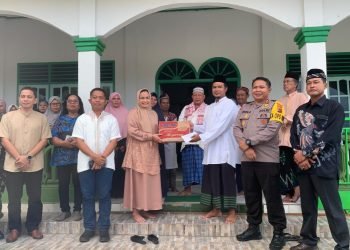 Pj. Sekda Mimika, Dr. Ida Wahyuni saat menyerahkan sembako secara simbolis kepada pengurus Masjid At-Taubah Kampung Mulia Kencana SP7.